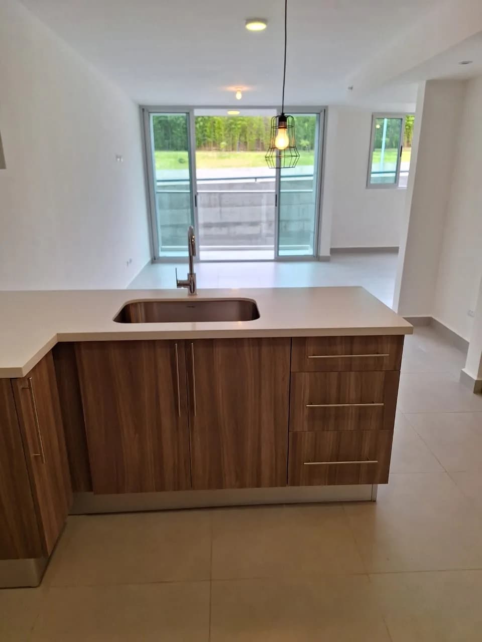 Open kitchen and living room with balcony doors